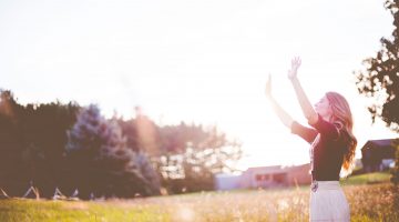 a woman raising her hands