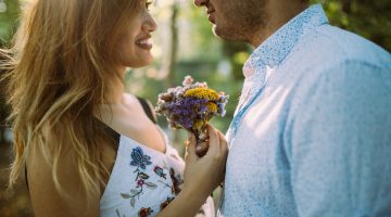 Awoman giving her husband fower